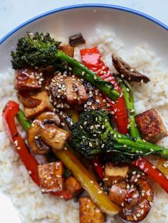 stir fry with broccoli, peppers, and tofu on top of white rice