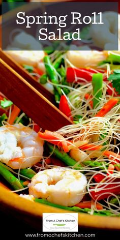 a salad with shrimp, asparagus and carrots is shown in a yellow bowl