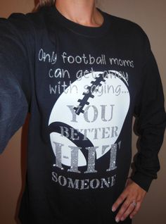 a woman wearing a black shirt with a football on it