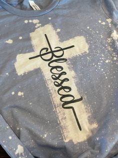 a t - shirt with the word jesus on it and a cross painted on it