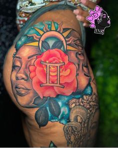 a woman's thigh with tattoos on it and a rose in front of her