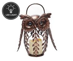 an owl shaped candle holder is shown with the light on