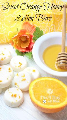 orange honey lotion bars are next to an orange slice and a bowl of honey