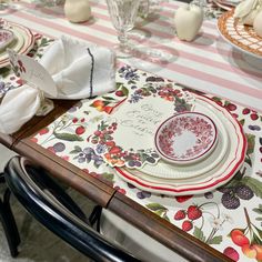 the table is set with plates and napkins