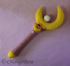 a crocheted banana with a golf ball in it's mouth on a purple background