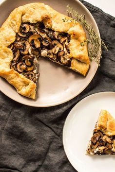 a slice of mushroom pie on a plate next to a piece of pie with one slice missing