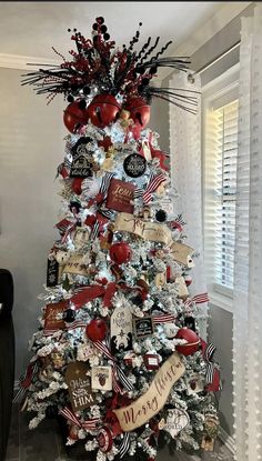 a christmas tree decorated with red, white and black ornaments