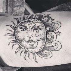 a sun and moon tattoo on the back of a man's arm, with stars around it