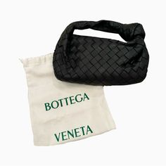 Bottega Veneta Mini Jodie Bag Black Excellent Condition - Only Worn Once! Top Handle Bag In Lambskin Leather With Soft Rounded Shape And Signature Knot Made Using Intrecciato Craftsmanship Mini Intrecciato Leather Top Handle Bag Single Compartment Zipper Closure Comes With Original Dustbag Material: 100% Lambskin Lining: Calfskin Color: Black Hardware: Gold Finish Height: 23 Cm | 9.1" Width: 28 Cm | 11" Depth: 8 Cm | 3.15" Handle Drop: 10 Cm | 3.9" Made In: Italy ***Do Not Bundle Listings Priced At $500 And Over - Sale Will Be Cancelled*** Luxury Handheld Pouch For Shopping, Luxury Handheld Shopping Pouch, Designer Black Top Handle Pouch, Designer Black Handheld Baguette Bag, Black Top Handle Pouch For Shopping, High-end Black Pouch Bag, Luxury Black Baguette Bag With Top Carry Handle, Black Clutch Pouch For Shopping, Luxury Black Shoulder Bag Pouch