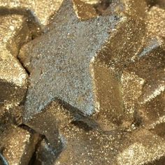 some silver glitter stars are on top of each other