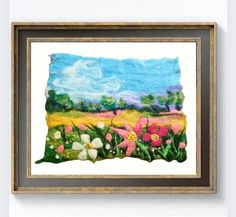 a painting hanging on the wall next to a framed frame with flowers in it and clouds above