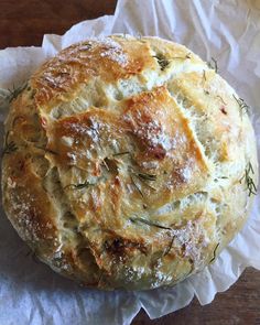 a round bread with some herbs on top of it