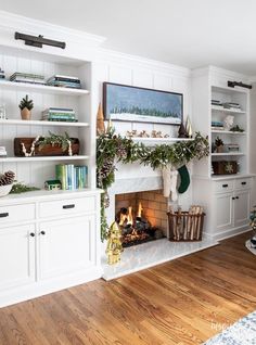 a living room filled with furniture and a fire place in the middle of a wooden floor