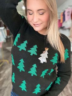 PREORDER: The Sequin Tree Womens Sweater Our mid weight sweater is crafted from a poly acrylic nylon blend, making it soft and cozy. This sweater features a repeating Christmas tree with a single sequin tree for extra sparkle. Available in 2 colors, small to XL sizes. TAT: 4-6 weeks Material: 88% POLYESTER, 7% ACRYLIC, 5% NYLON Colors: Red, Black Sizes: S-XL Model Stats: Wearing size large at 5'7", 175lbs, 36D in the bust. 23 weeks pregnant PREORDER END MONDAY OCTOBER 23RD AT NOON CST Winter Sequin Sweater, Black Winter Sweater With Sequins, 23 Weeks Pregnant, Weeks Pregnant, At Noon, Womens Sweater, Pregnancy Week By Week, Kids Swimwear, Custom Clothes