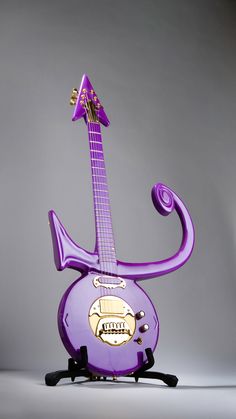 the purple guitar is shaped like an animal