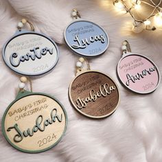 four wooden ornament with names and dates hanging on a white furnishing