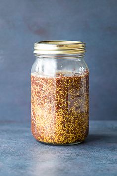 a glass jar filled with yellow and red sprinkles