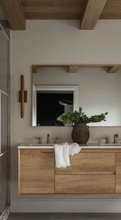 a bathroom with two sinks and a large mirror