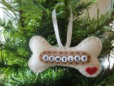 a dog bone ornament hanging from a christmas tree