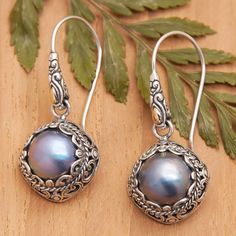 Two exquisite cultured Mabe pearls in a lovely blue hue are encapsulated by intricate engraved sterling silver motifs in this pair of fabulous dangle earrings designed by Bali's Dewi Putera. Featuring subtle 18k gold-plated accents, the heavenly earrings are sure to catch the eye and fill any attire with sophistication. Intricate Design Round Pearl Earrings Gift, Gift Round Pearl Earrings With Intricate Design, Ornate Pearl Earrings As Gift With Intricate Design, Ornate Pearl Drop Earrings For Gifts, Mabe Pearl, Pearl Dangle Earrings, Pretty Jewelry, Pearl Earrings Dangle, Pretty Jewellery