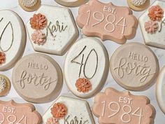 decorated cookies with the names and dates of each year are displayed on a white surface