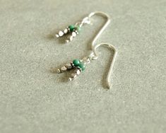 These adorable small little turquoise earrings have turquoise and glittering sterling beads in tiny double dangles hanging from simple sterling silver ear wires. Minimal and hip, these earrings are light and easy to wear, a bit tribal and modern at the same time. They look pretty on their own, but just as pretty paired with other jewelry. Earrings measure a little over 3/4 inch, approximately, including ear wires. Photos are taken close up, and make make stones appear larger. All sterling silver Sterling Silver Dangle Jewelry With Tiny Beads, Silver Sterling Earrings With Tiny Beads, Sterling Silver Earrings With Tiny Beads For Gift, Bead Earrings, Earrings Sterling Silver, Turquoise Earrings, Minimalist Earrings, Chicago Il, Ear Wires