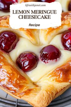 a close up of a pastry with cherries on it and cheese in the middle