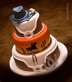 a three tiered cake with cowboy hats on top