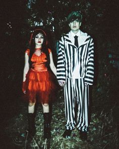 two people dressed in costumes standing next to each other