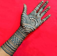 a person's hand is decorated with hennap and intricate designs on it