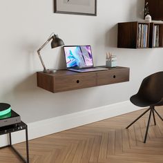 a laptop computer sitting on top of a wooden shelf next to a desk with a record player