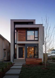 a two story house with wood and glass on the front