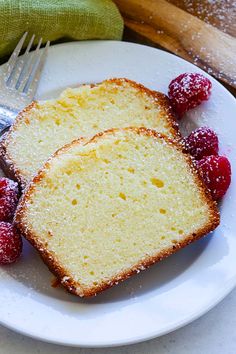 two slices of pound cake on a plate with raspberries