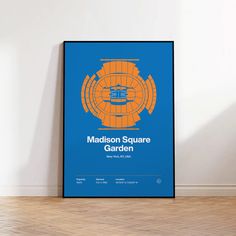 a blue and orange poster with the words madison square garden on it in front of a white wall