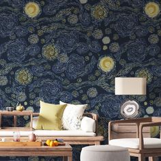 a living room scene with focus on the sofa and chair, wallpapered in blue