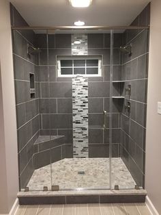 a walk in shower sitting next to a tiled wall and white tile floored walls