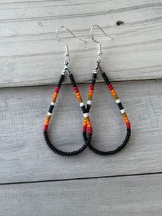 Octoberfest Boho Aztec Teardrop Earrings. Hypoallergenic materials. Seed bead teardrop earrings. Western/Native American style earrings. Very comfortable and light weight to wear. Will look great with a simple outfit. Processing time 3-5 business days. Cheap Teardrop Beaded Earrings, Handmade Black Bohemian Teardrop Earrings, Bohemian Teardrop Earrings With Ear Wire, Bohemian Black Teardrop Beaded Earrings, Black Bohemian Teardrop Dangle Earrings, Festival Teardrop Earrings With Ear Wire, Bohemian Adjustable Teardrop Earrings With Colorful Beads, Beaded Dangle Teardrop Earrings For Festivals, Adjustable Bohemian Teardrop Earrings With Colorful Beads