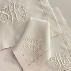 two monogrammed white linens with embroidered initials