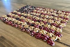 an american flag made out of granola on a wooden floor