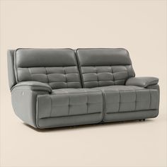 the reclining sofa is made from grey leather and has two seats on each side