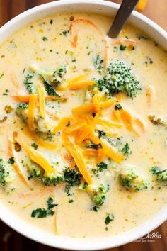 a white bowl filled with broccoli cheese soup