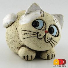 a ceramic cat figurine sitting on top of a table