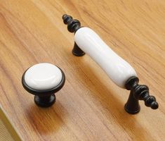 two black and white knobs on a wooden surface