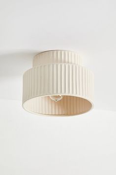 a white light fixture hanging from the ceiling