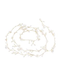 a white flower and pearl headband on a white background