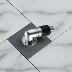 the faucet is attached to the shower head on the marble tile flooring