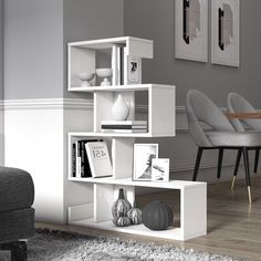 a white shelf with pictures and books on it in the corner of a living room