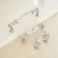 a bathtub with chrome handles and knobs next to it's drain hole