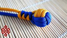 a blue and yellow rope on top of a white mat