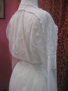 "1914, 36\" bust , elaborate cotton lace on net, wedding dress. dress has lace edged net apron, beneath belt, around hips. Bodice is entirely worked in lace, and has a narrow lace ruffle edged alone V shaped neckline. Sleeves are long with lace cuffs, with a net middle, and a lace band around the upper arm. The gown is fastened in front with hooks and eyes from bodice to waist, and snaps from waist to thigh. Measurements: bust 36\" waist 26\" shoulder to shoulder 17\" sleeves 21\" arm holes 9\" Vintage Lace With Lace Trim For Ceremony, Fitted Victorian Lace With Lace Trim, Victorian Wedding Dress With Lace Sleeves, Victorian Fitted Scalloped Lace, Vintage White Lace Patchwork For Wedding, Regency Style Lace Victorian Wedding Dress, White Lace Victorian Wedding Dress, White Victorian Wedding Dress With Lace Trim, Victorian Lace Trim Dress For Vintage Events